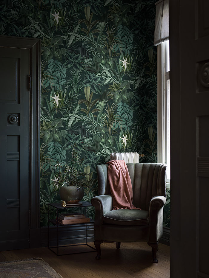 Dark room corner with biophilic accent wall, vintage armchair draped with a throw, showcasing elegant home decor ideas. Dark room corner with biophilic accent wall, vintage armchair draped with a throw, showcasing elegant home decor ideas.