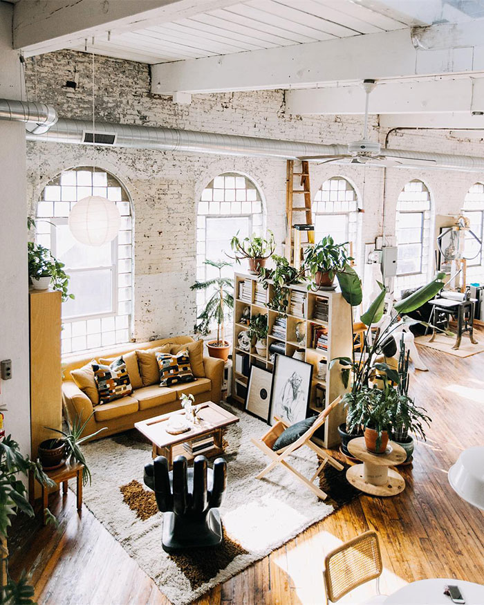 Spacious industrial living room with abundant plants, natural light, and stylish home decor ideas featuring designer insights. Spacious industrial living room with abundant plants, natural light, and stylish home decor ideas featuring designer insights.