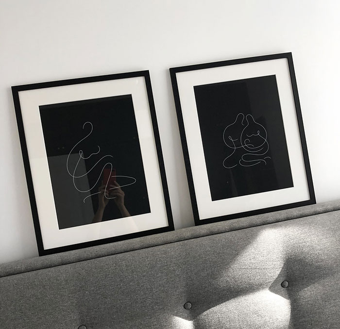 Two minimalist paintings with line art on a grey bedhead, showcasing modern home decor ideas and design style. Two minimalist paintings with line art on a grey bedhead, showcasing modern home decor ideas and design style.