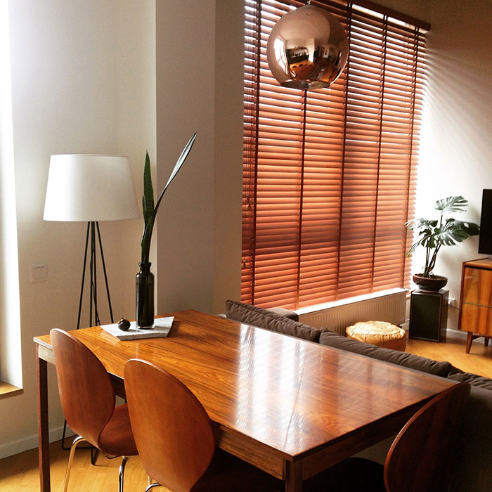 Brown mid-century modern living room corner featuring wood furniture and warm natural light for home decor ideas. Brown mid-century modern living room corner featuring wood furniture and warm natural light for home decor ideas.