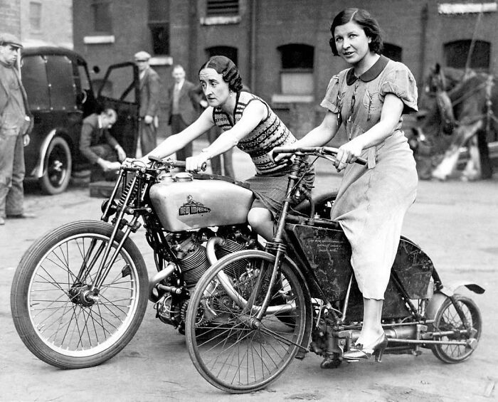 Two Ladies Astride An 1895 Crank Drive Motorcycle And A 500 New Imperial Twin