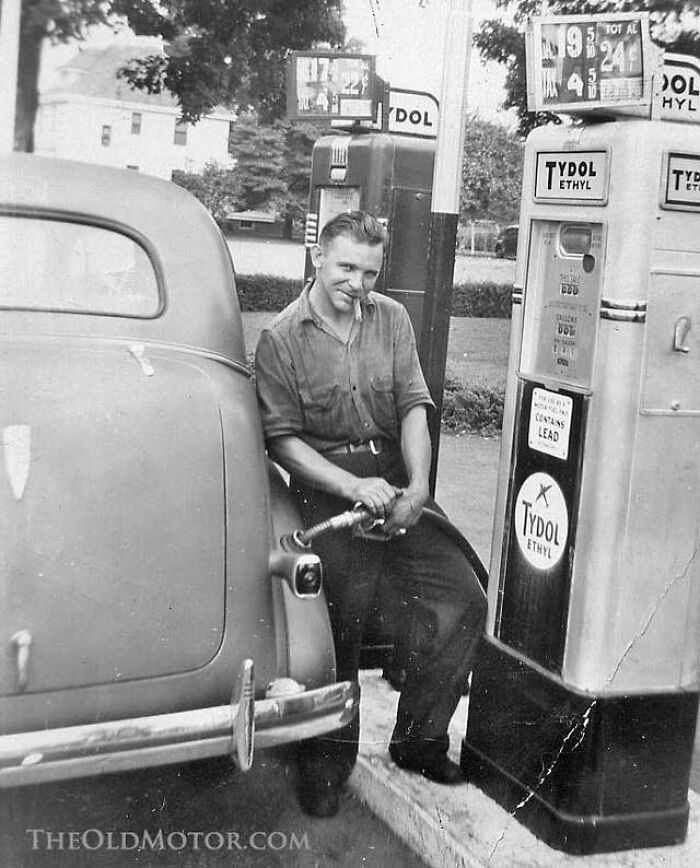Man Putting Gas In His Car While Smoking A Cigar, 1900s
