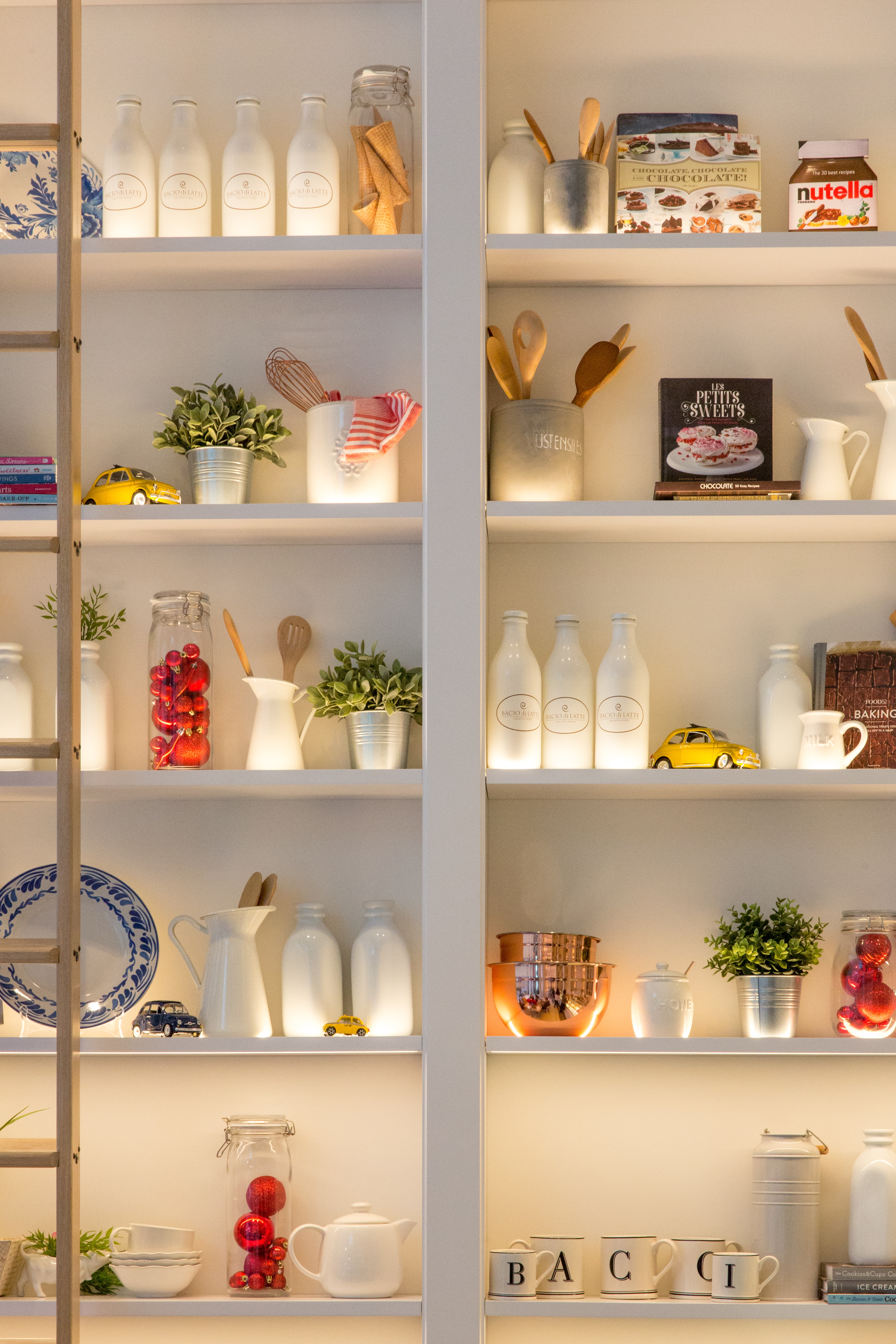 Kitchen with open shelves white ceramic bottles on shelf and lights