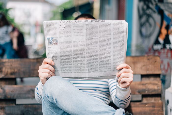 person holding newspaper