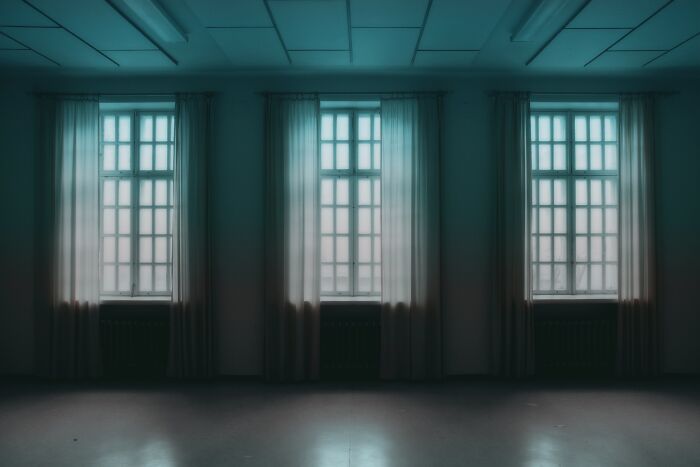 Dark room with three windows