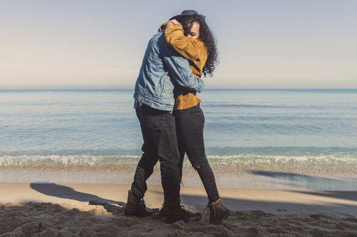 Man and woman hugging on seashore