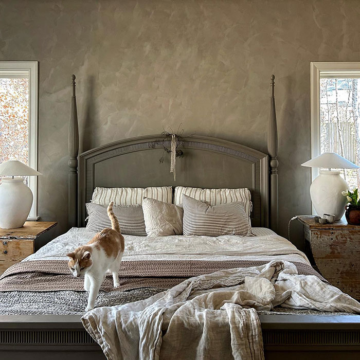 Cozy white and grey bedroom with a cat on bed 