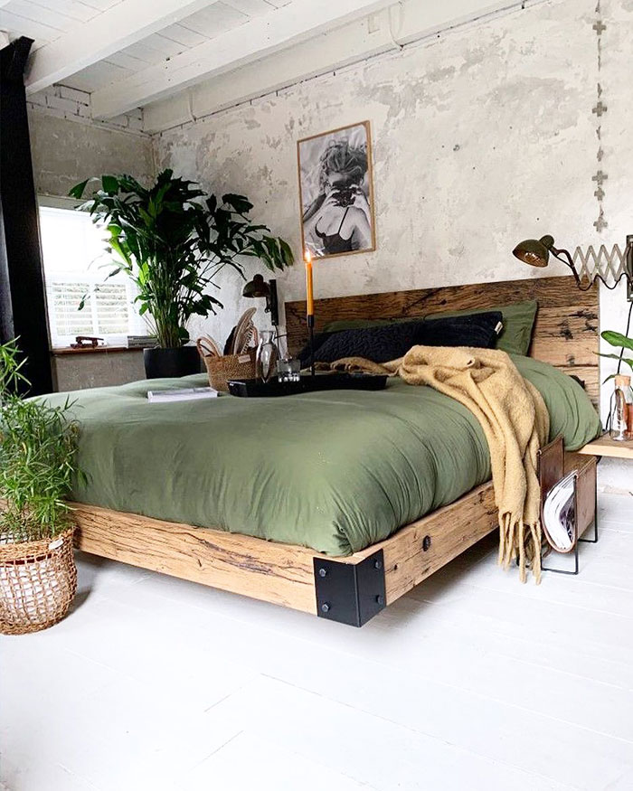 Spacious industrial style master bedroom with green bedding, wooden bed frame, plants, and cozy decor for master bedroom ideas. Spacious industrial style master bedroom with green bedding, wooden bed frame, plants, and cozy decor for master bedroom ideas.