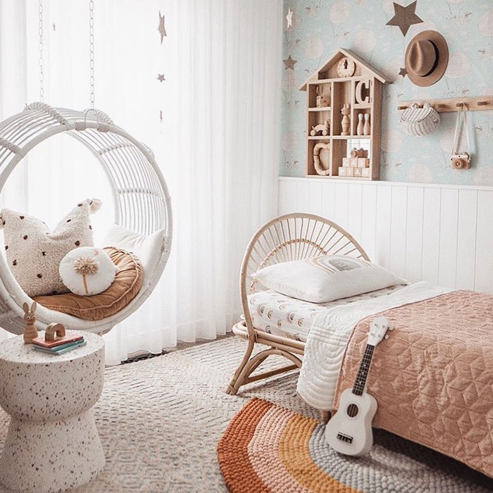 Cozy coastal design bedroom with rattan swing