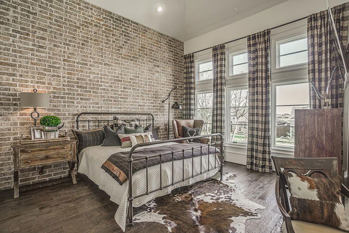 Exposed brick wall in a cozy bedroom