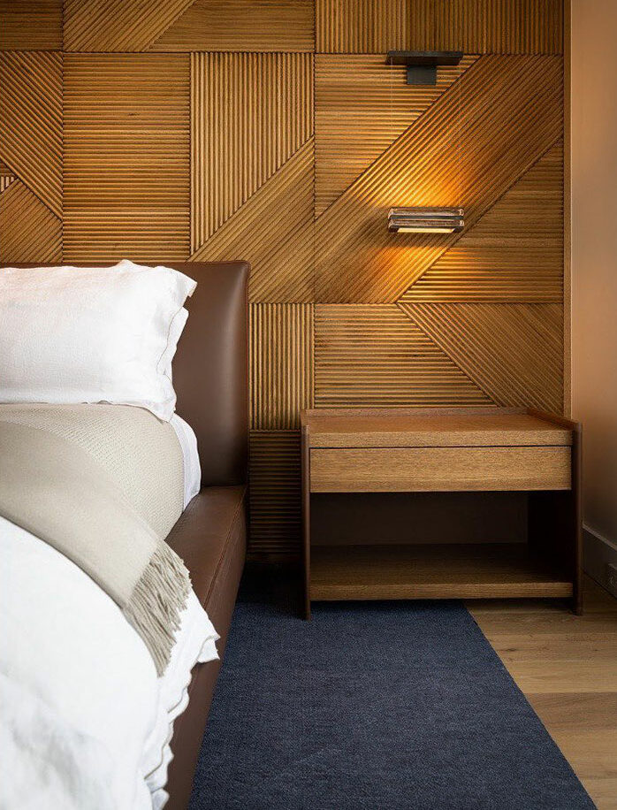 Wood paneling bedroom with modern bedside table and leather bed frame, showcasing stylish master bedroom ideas and design elements. Wood paneling bedroom with modern bedside table and leather bed frame, showcasing stylish master bedroom ideas and design elements.