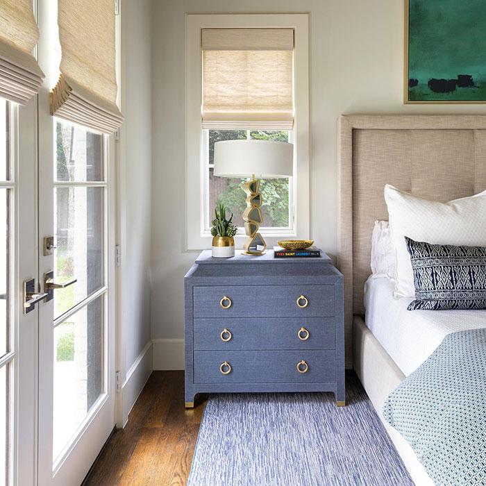 Blue nightstand with gold accents next to bed in a master bedroom showcasing stylish master bedroom ideas and design. Blue nightstand with gold accents next to bed in a master bedroom showcasing stylish master bedroom ideas and design.