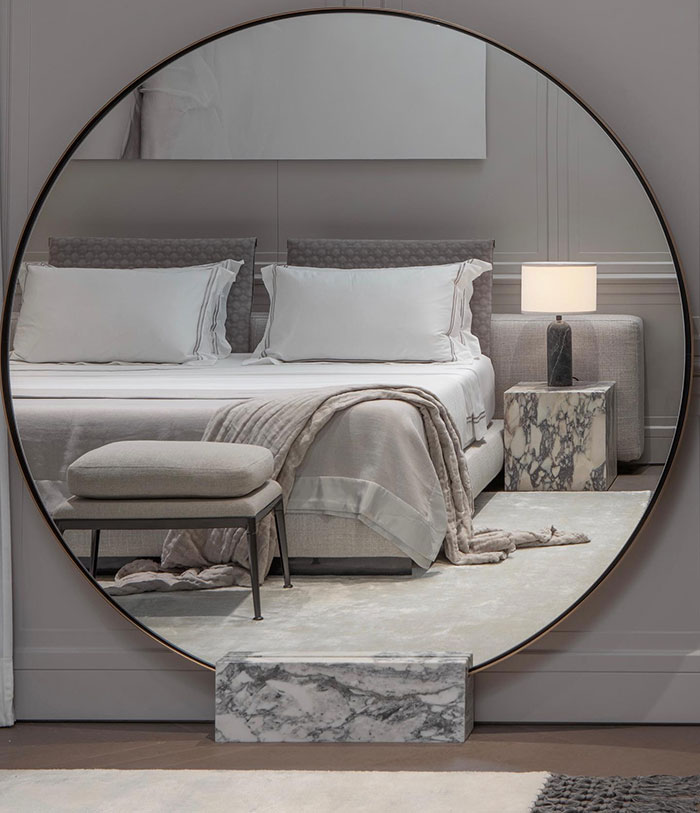 Big Round mirror in a cozy spacious bedroom 