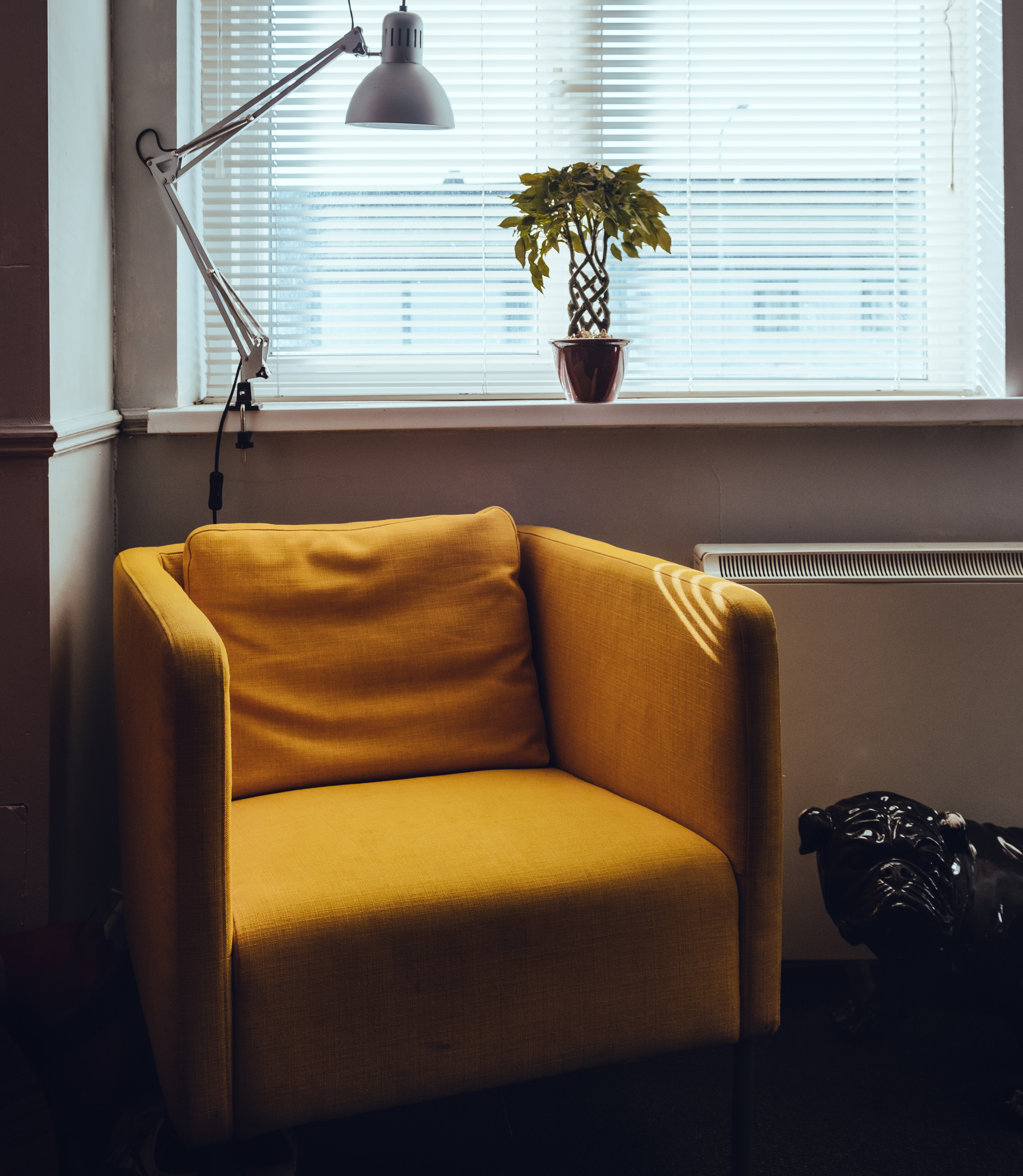 yellow armchair near window