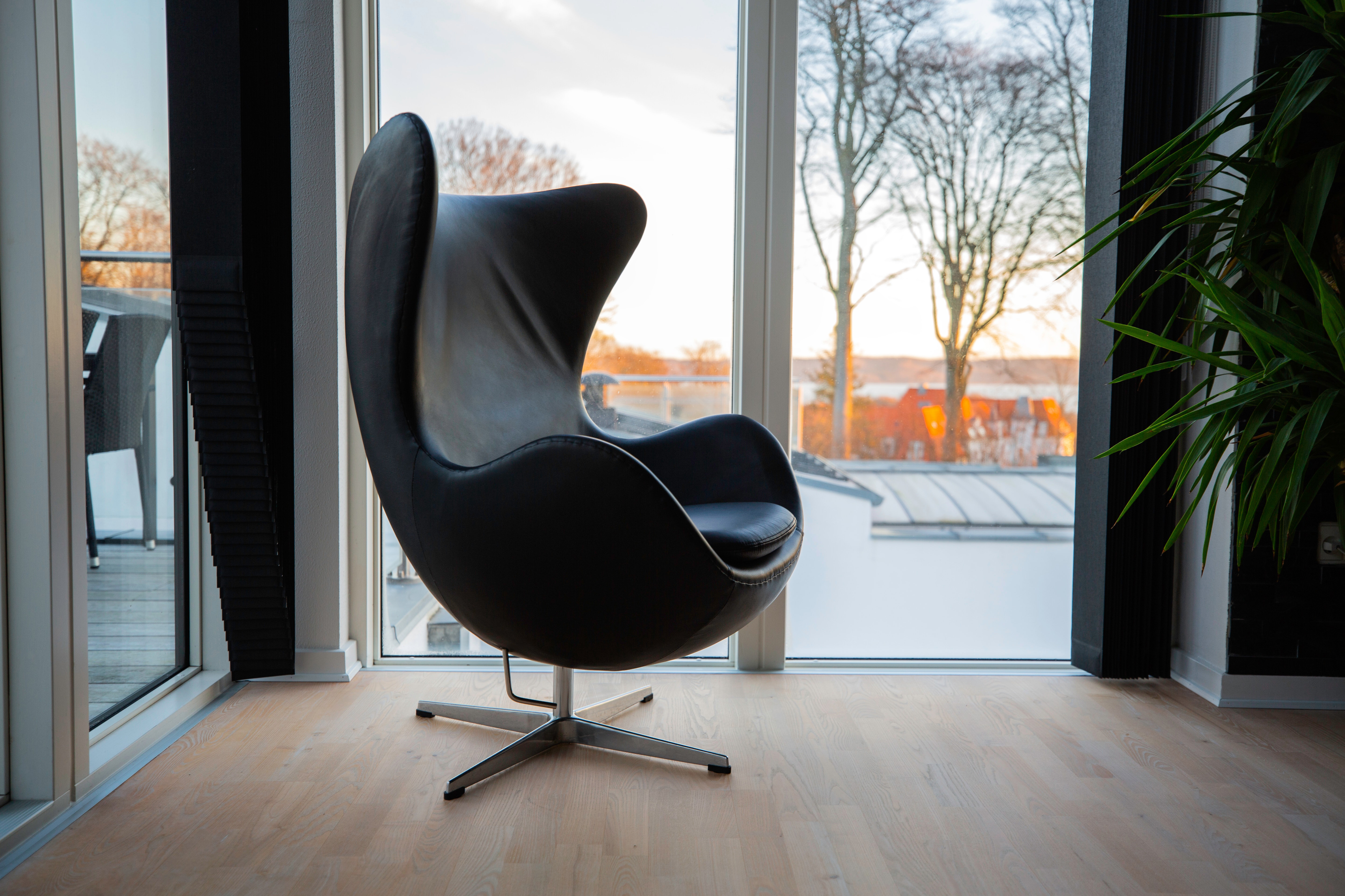Leather egg chair near the window
