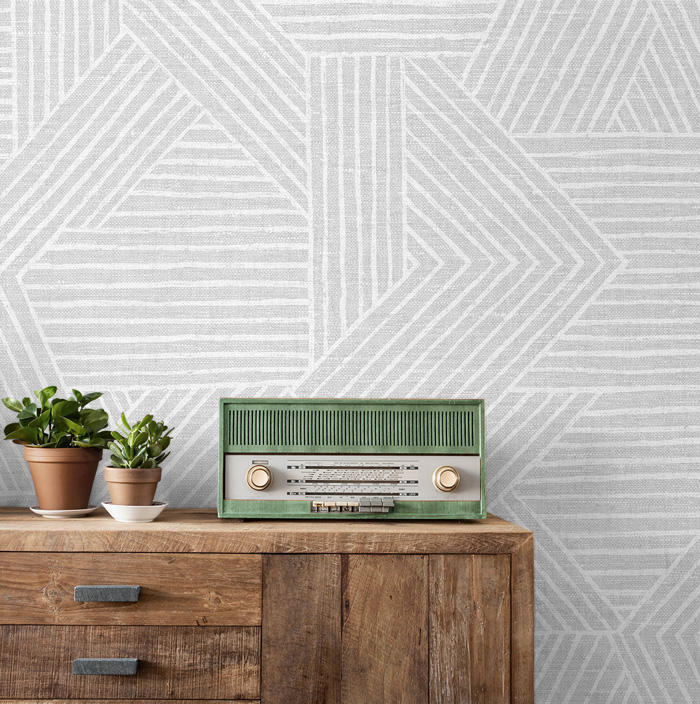 Wallpaper with geometrical shapes near an old green radio 