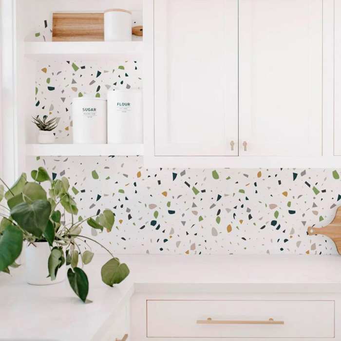 White kitchen cabinets and wallpaper with colourful pattern 
