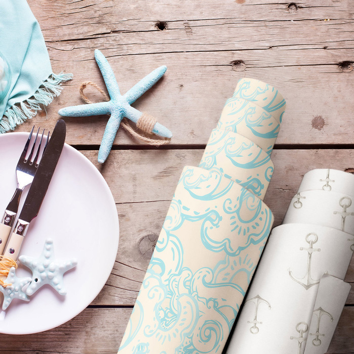Two wallpaper rolls on a wooden table 