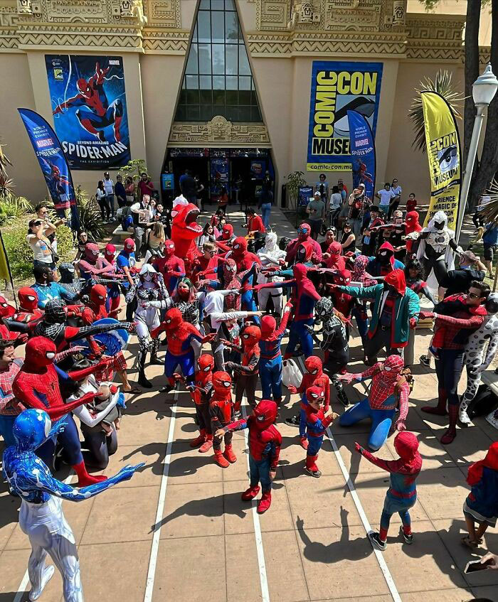 A group of people dressed in Spiderman costumes posing at Comic Con.