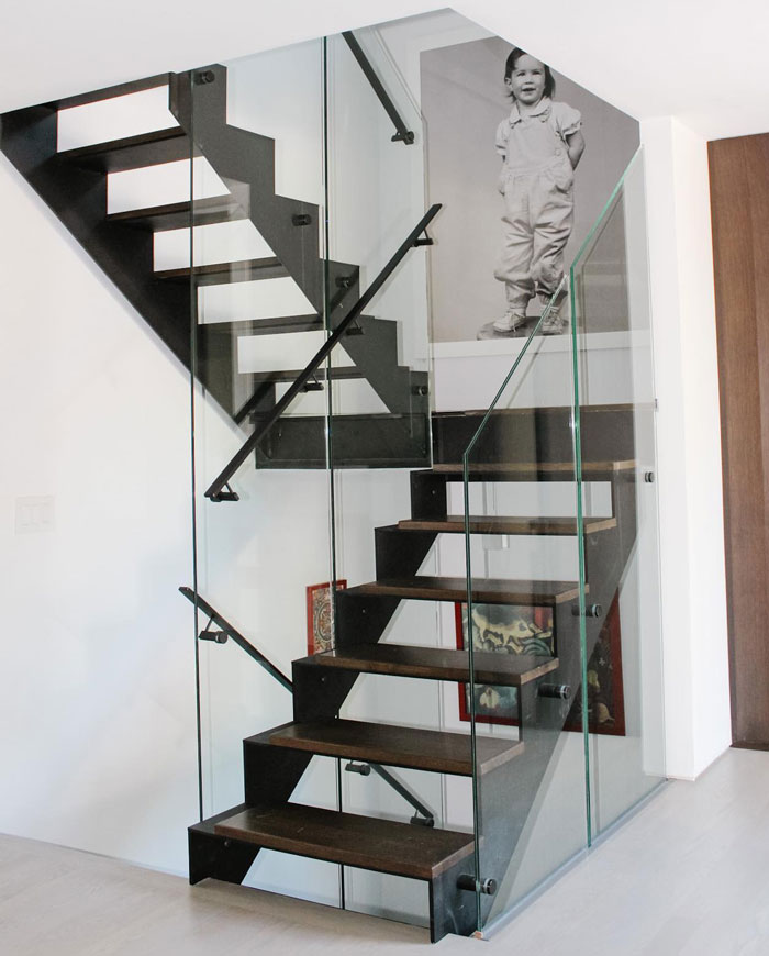 industrial wood and metal staircase with glass railings