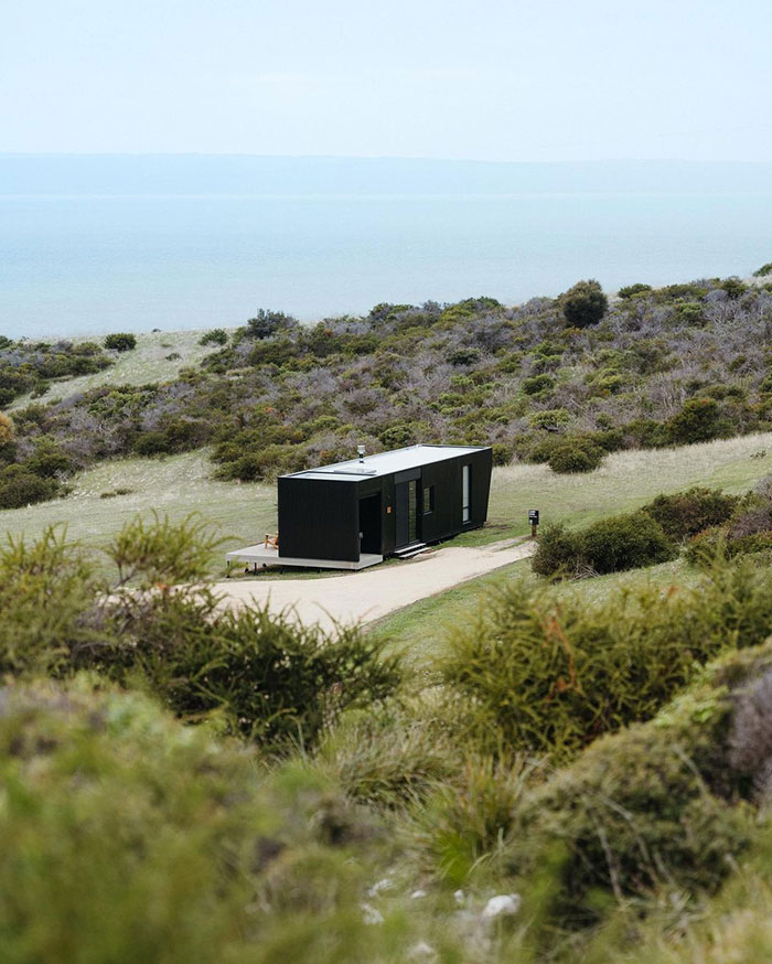 Black container studio in the fields.