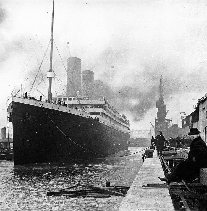 People walking by the Titanic at the docks of Southampton