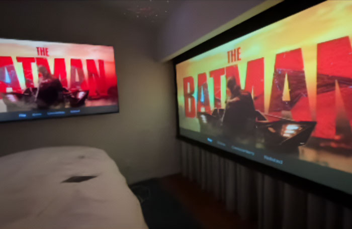 Home theater with Batman movie screens, referencing mysterious online posts. Home theater with Batman movie screens, referencing mysterious online posts.