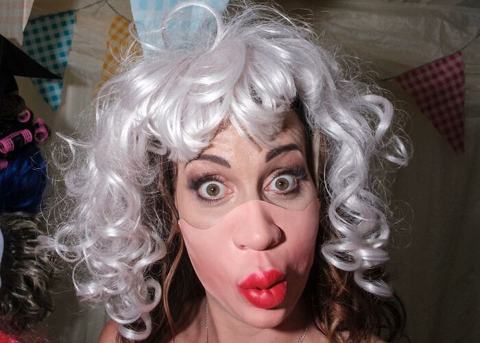 A Photograph Of A Woman With A Mask