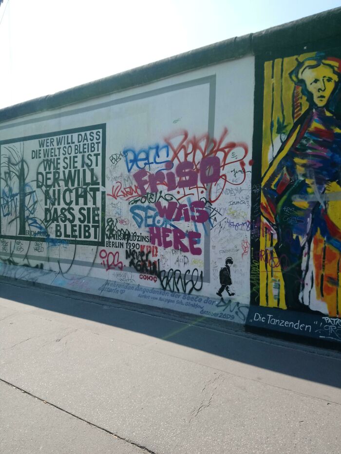 Jerks Tagging Over The Artwork On The Berlin Wall