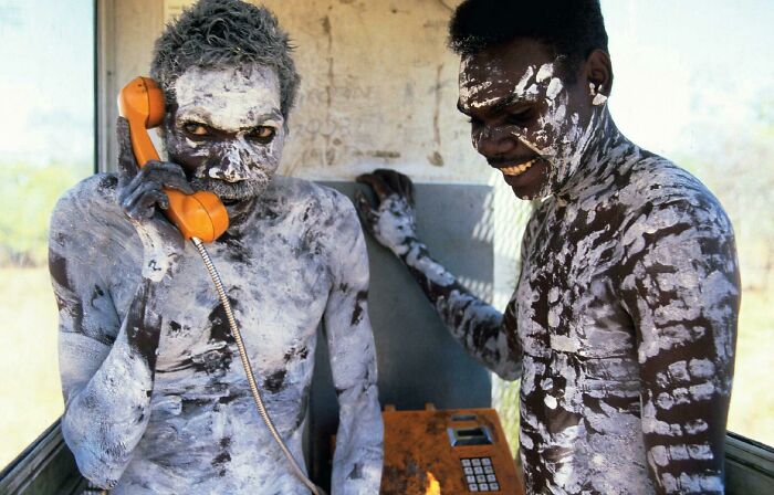 Aboriginal Man, Tom Noytuna And His Son, Use A Newly Installed Telephone For Their First Time At A Remote Outstation At Korlobidahdah, Central Arnhem Land, Australia ... (C.1980) 