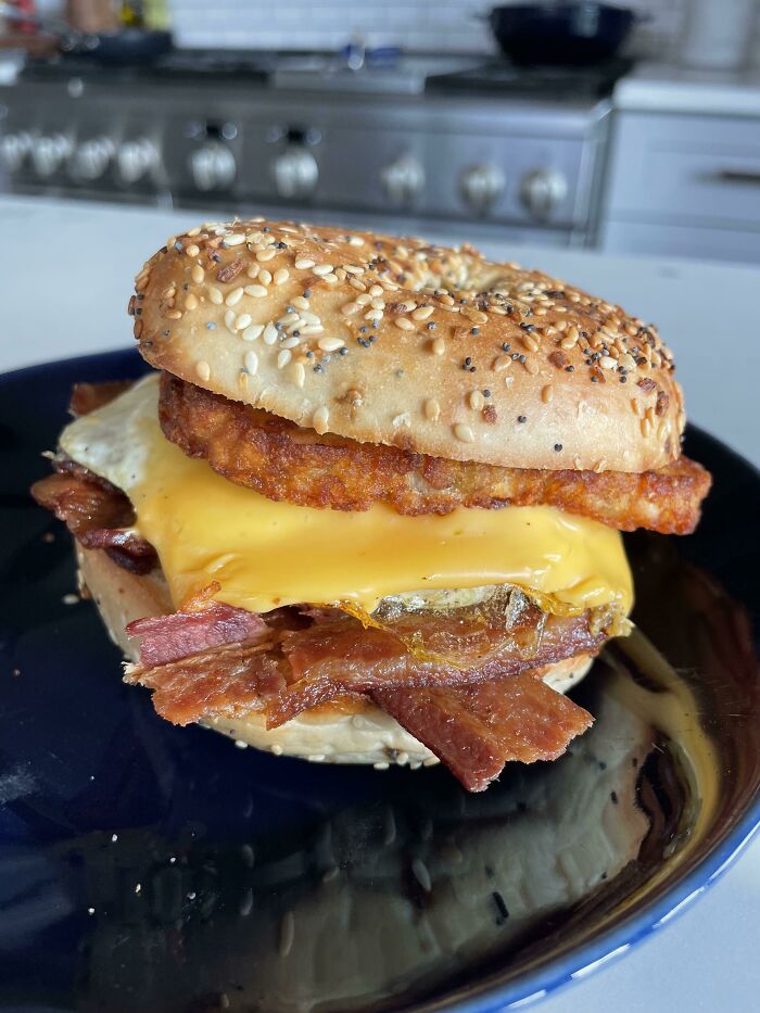 [homemade] Another Day Another Breakfast Sandwich. Thick Cut Bacon, Fried Egg, American Cheese, Hash Brown, And Hot Honey On A Everything Bagel