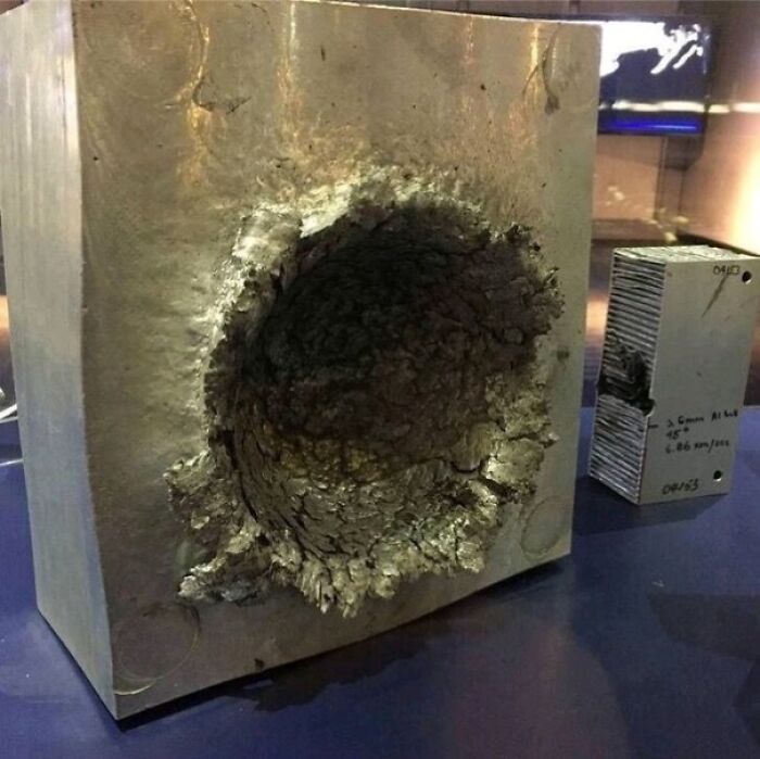Block Of Aluminum After It Was Hit By A 14-Gram Piece Of Plastic That Was Traveling 24,000 Feet Per Second (26,000 Kmph/16,000 Mph) In Space