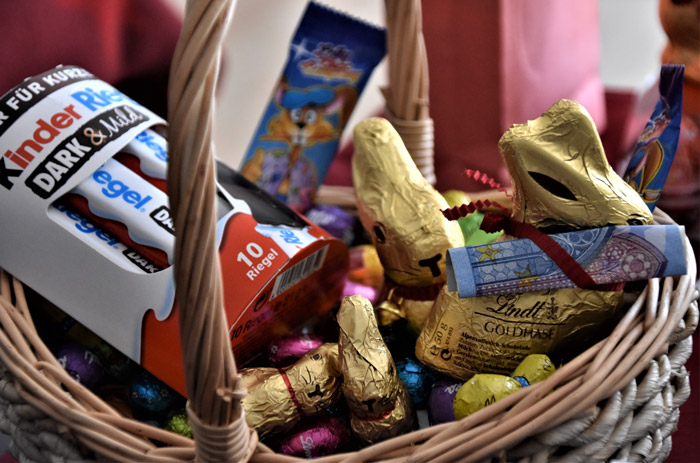 Brown wicker basket with candies and chocolate