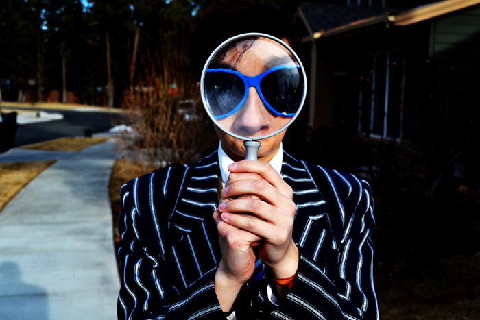 Person using magnifying glass