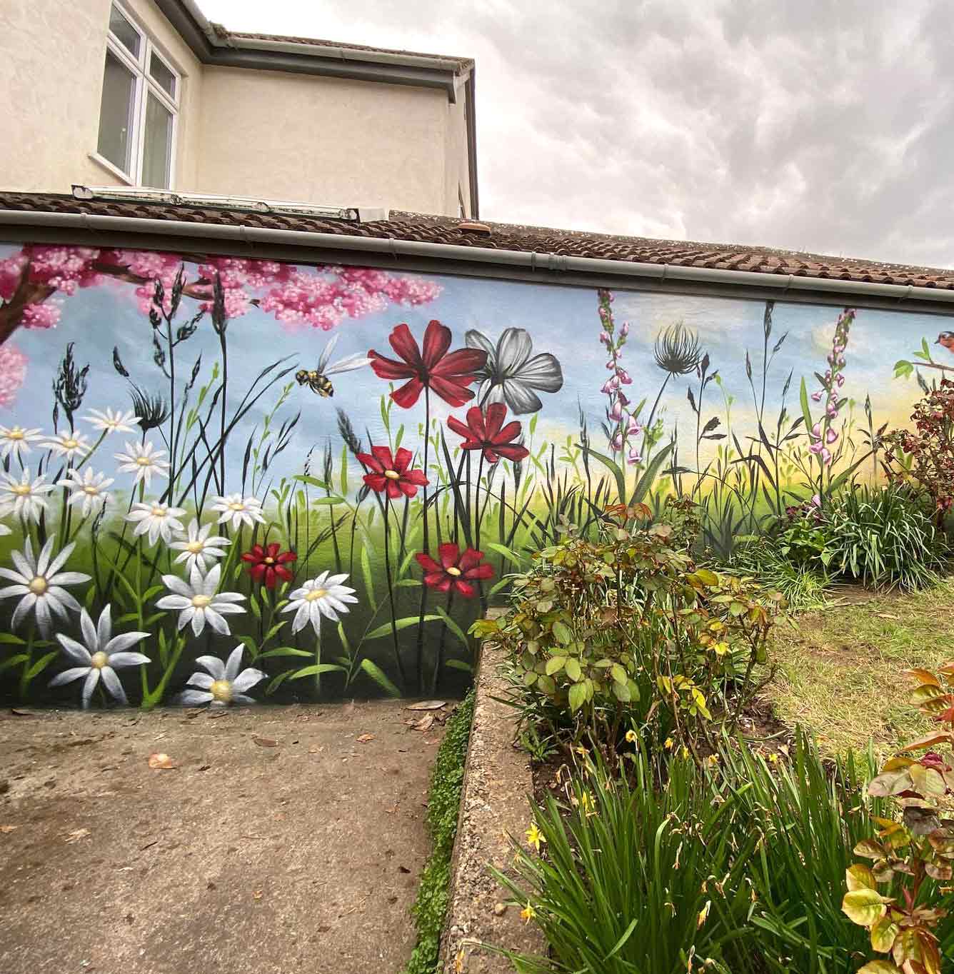 Backyard wall mural with painted flowers