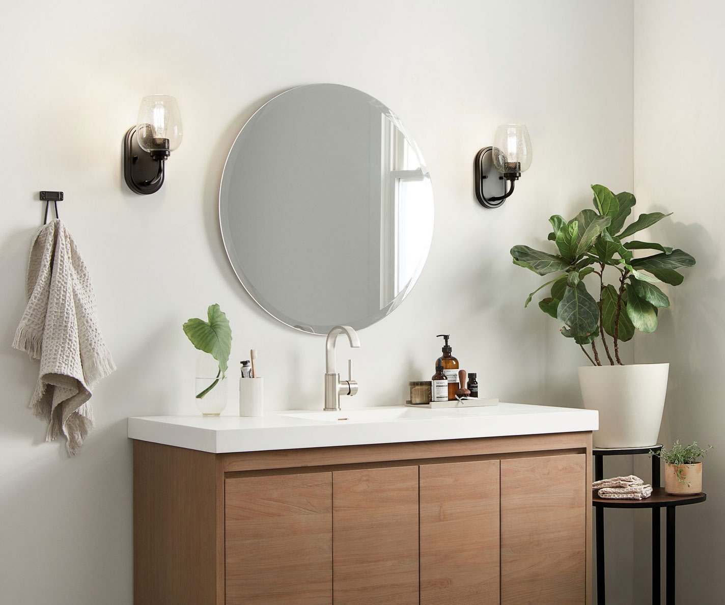 Bathroom with wall-mounted vanity lights on either side of the mirror