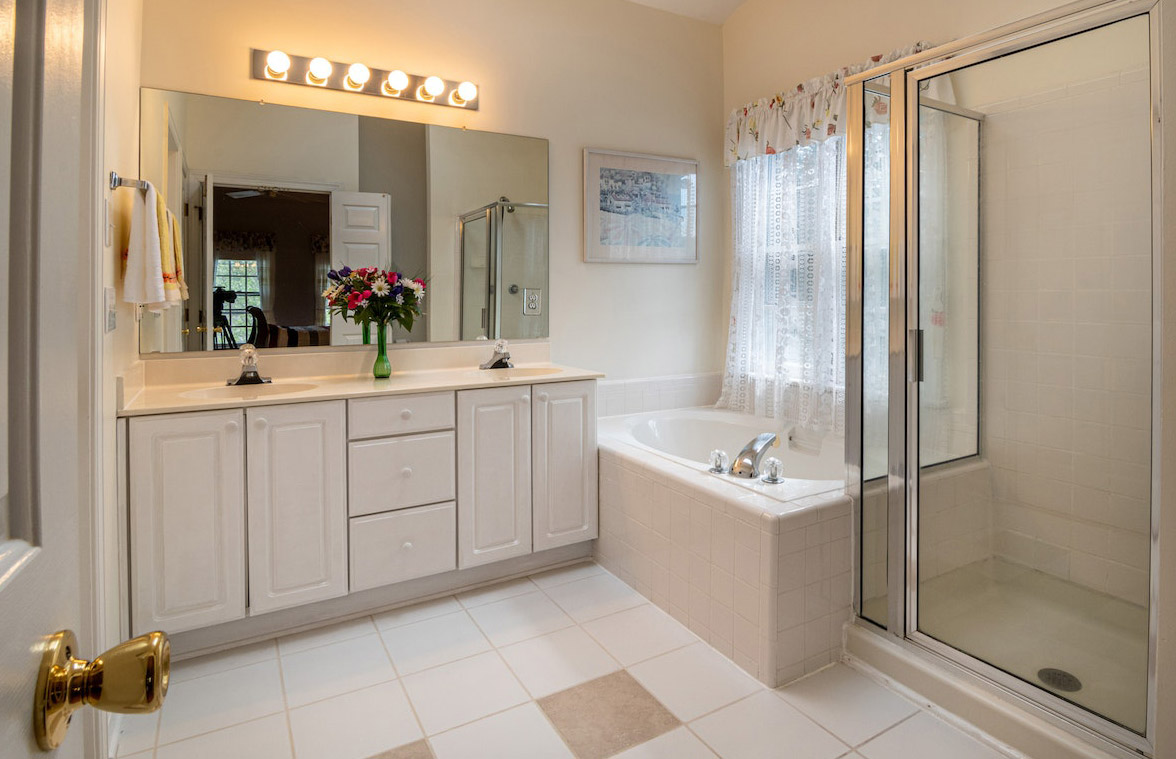 Bathroom with warm toned lights over the mirror Bathroom with warm toned lights over the mirror