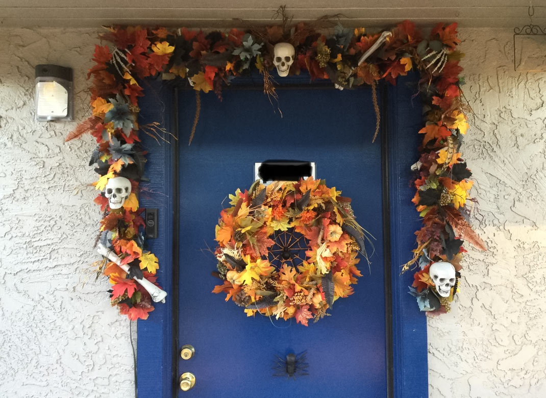 Blue door with autumn leaves garland