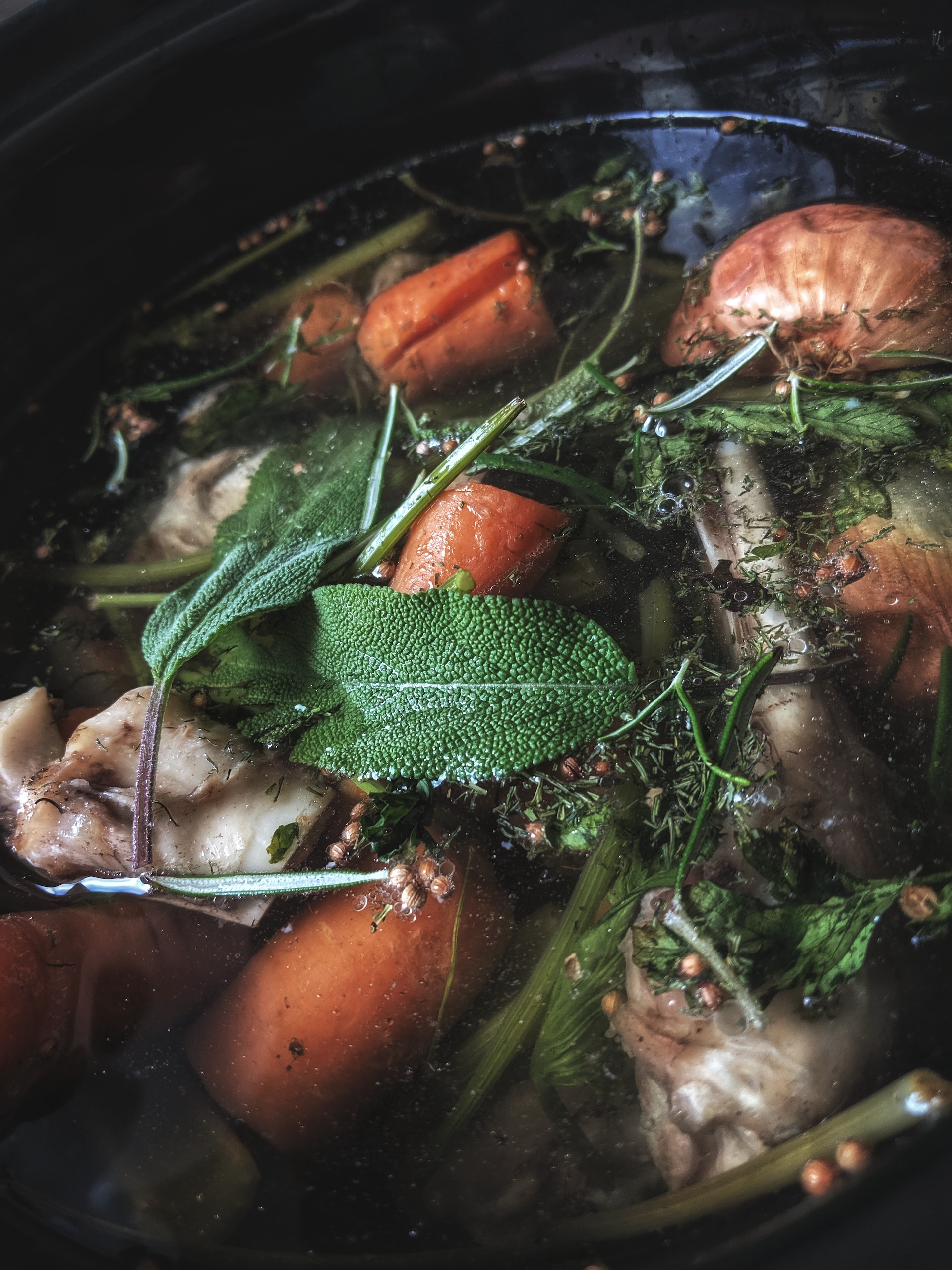 Bone broth with carrots, herbs, and chicken bones, rich in minerals and nutrients for dogs. Bone broth with carrots, herbs, and chicken bones, rich in minerals and nutrients for dogs.