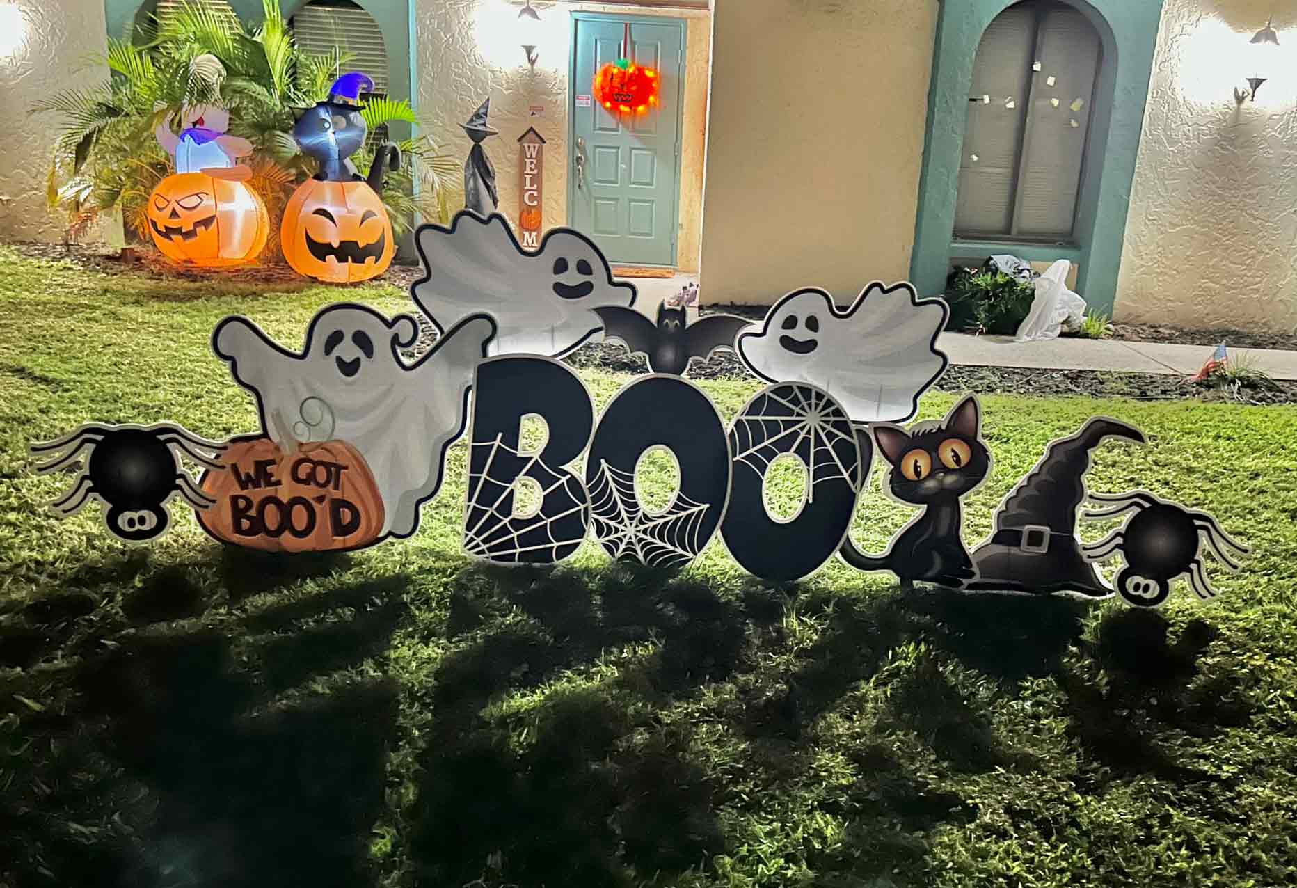 Halloween decoration BOO letters with ghosts in the yard