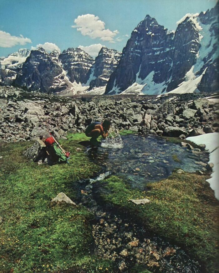 A Hiker Stops To Refresh In The Valley Of The Ten Peaks, Alberta, Canada, 1980