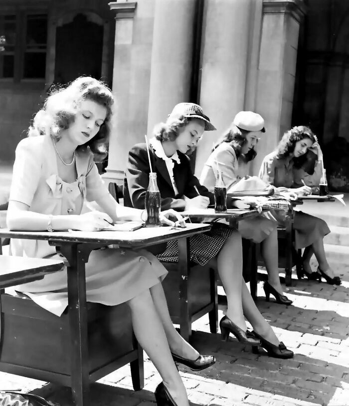 A Group Of 1940s Students Doing Their Schoolwork While Drinking Some Coca Cola