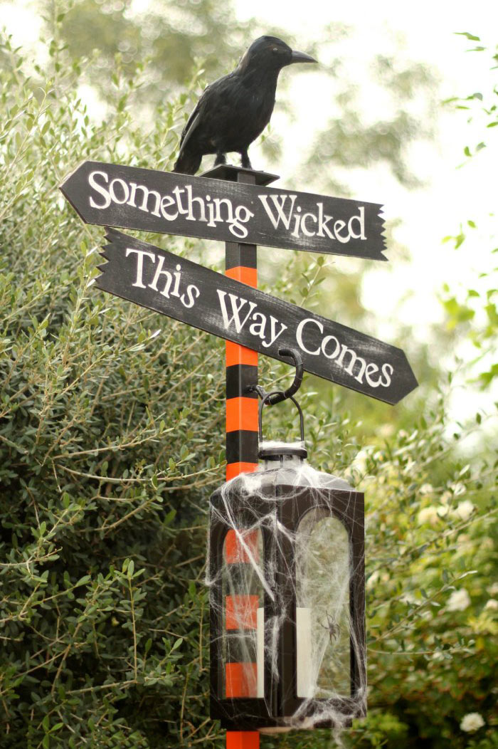 DIY Halloween directional sign post with raven and lantern
