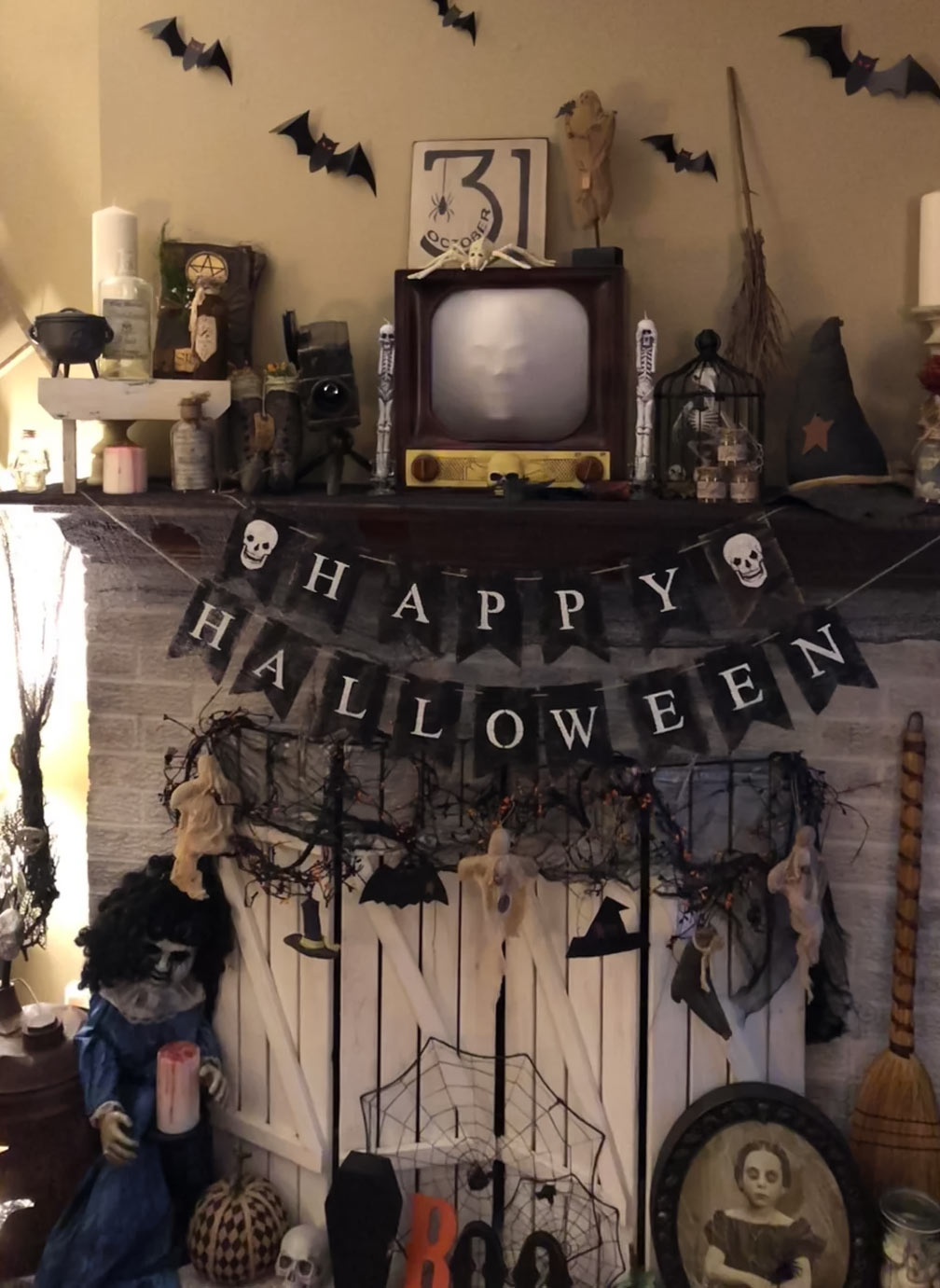 Fireplace decorated with garland banner Happy Halloween
