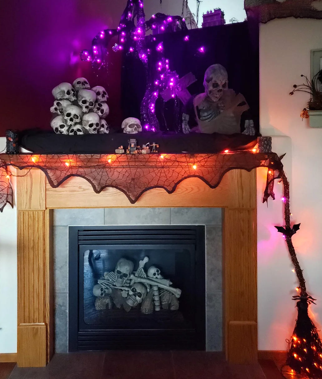 Fireplace decorated with skulls and broom