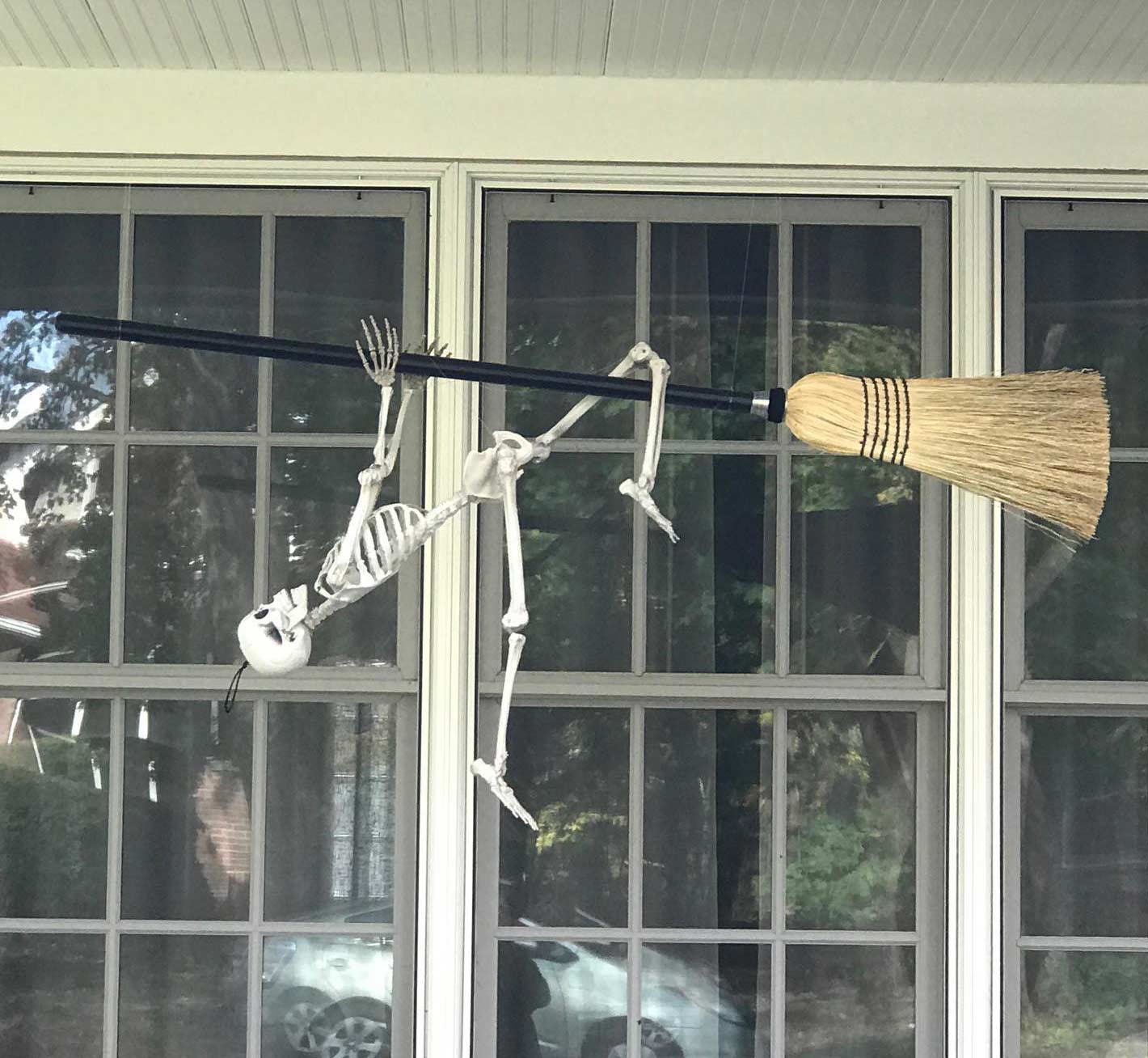 A hanging broom with a skeleton