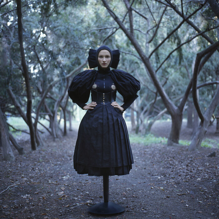 An image of a woman in black costume