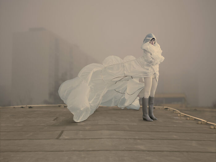 An image of a woman in white cloud-looking gown