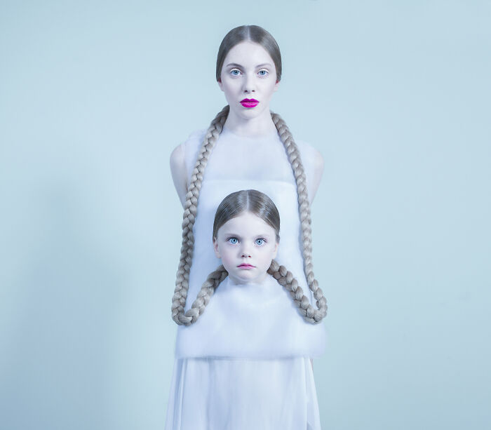 An image of a woman connected by braids with a girl