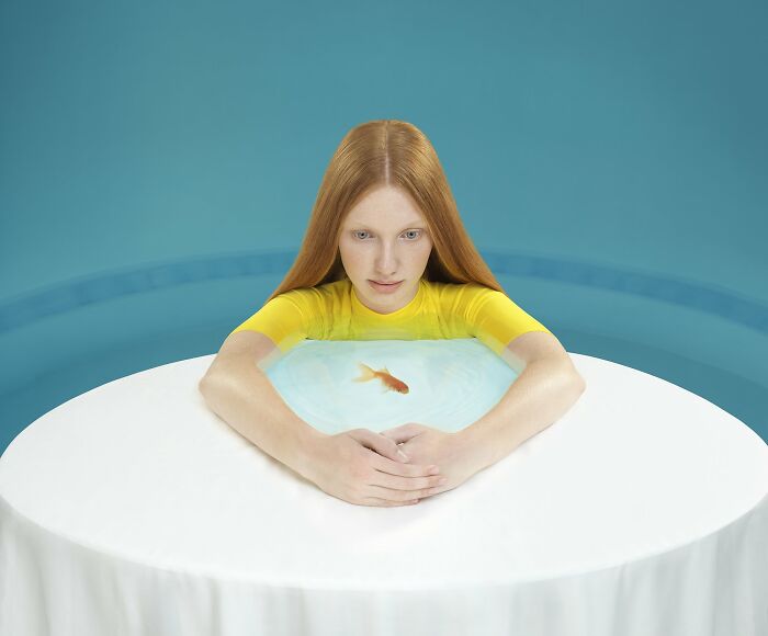 An image of a girl and a goldfish